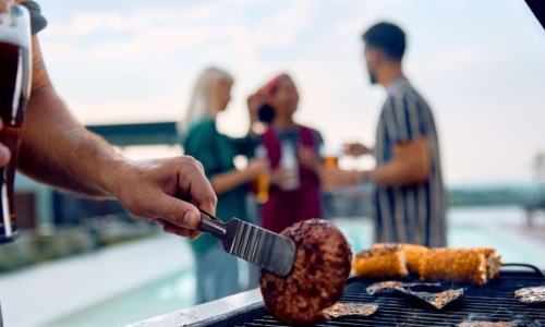 a person cooking food on a grill