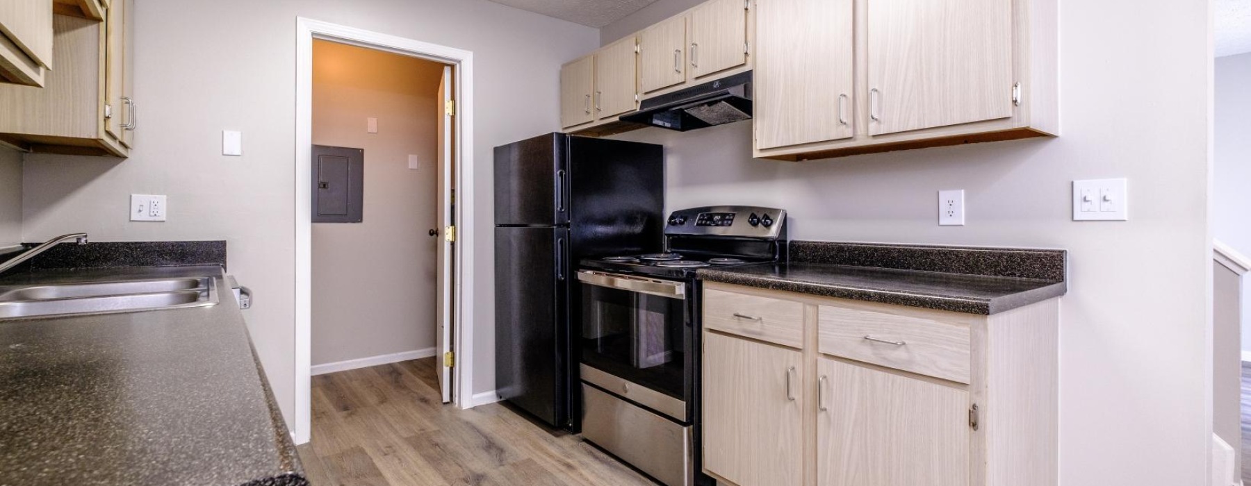 a kitchen with wooden cabinets