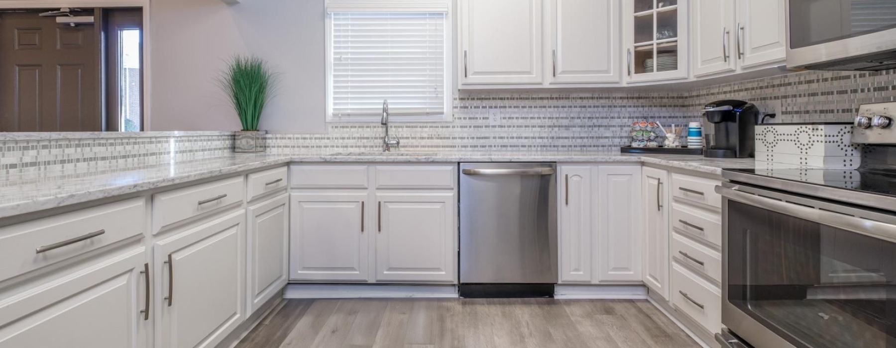 a kitchen with white cabinets