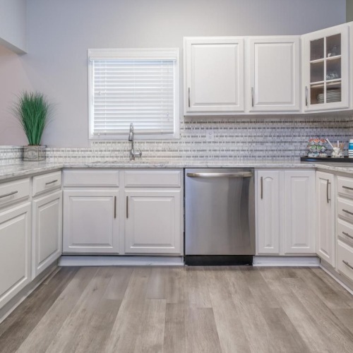a kitchen with white cabinets
