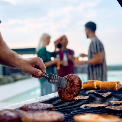 a person cooking food on a grill