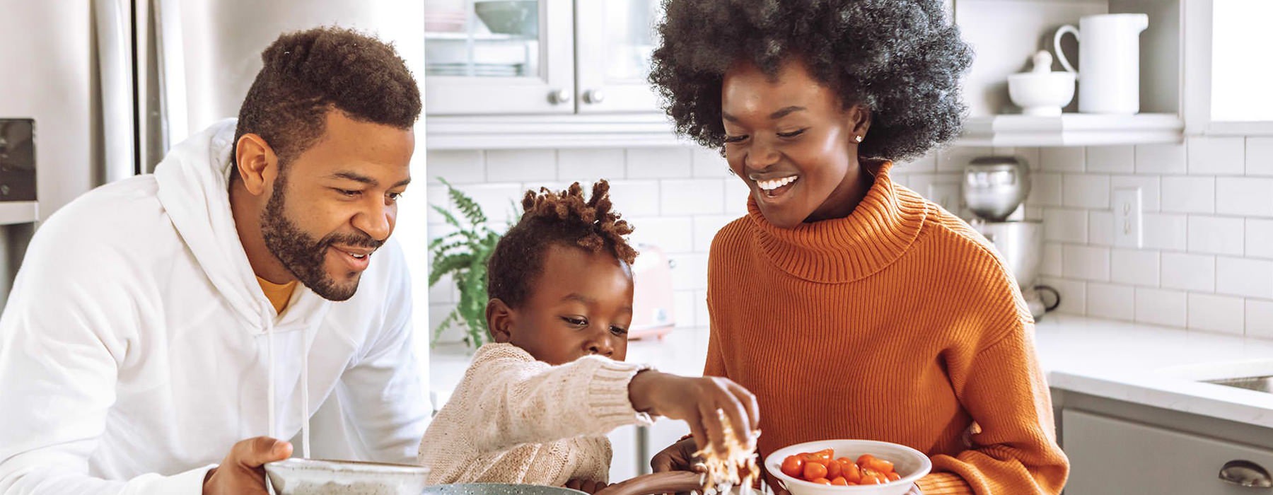 family cooks in kitchen